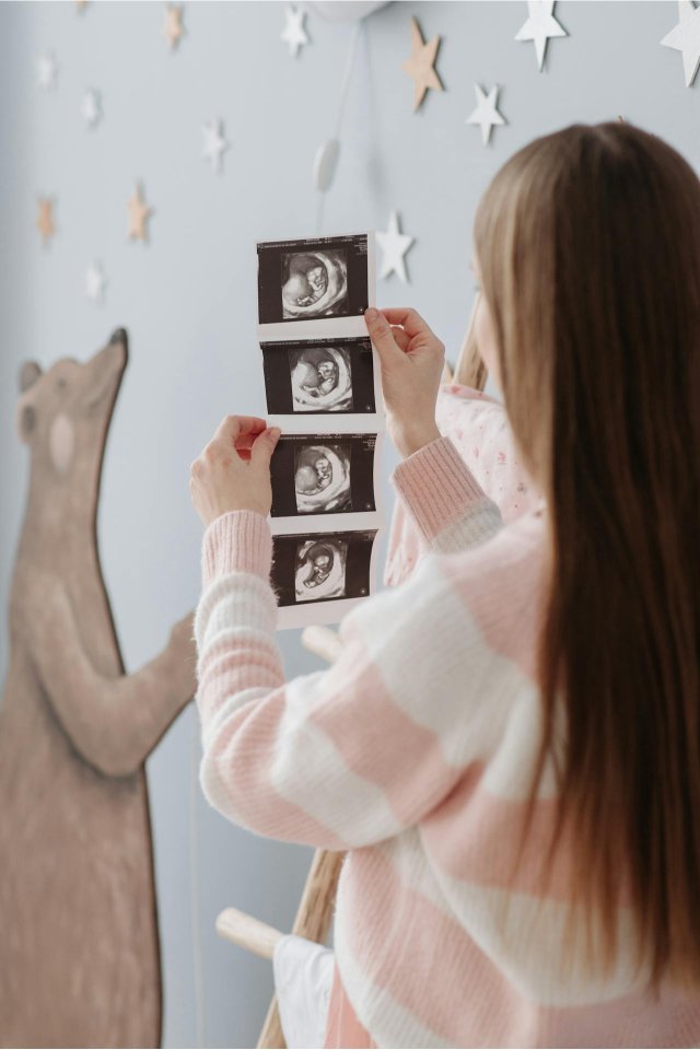 Woman holding a sonogram of her baby